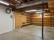 Unfinished basement space with exposed ceiling, wood shelving and concrete floor at 11824 E Basswood Ln, Franktown, CO 80116