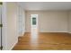 Bedroom boasts hardwood floors with built-in shelves, a doorway, and three windows at 11824 E Basswood Ln, Franktown, CO 80116