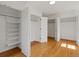 Bedroom with hardwood flooring and three spacious closets, including one with shelves at 11824 E Basswood Ln, Franktown, CO 80116