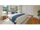 Comfortable bedroom featuring a well-made bed with matching nightstands and two windows at 11824 E Basswood Ln, Franktown, CO 80116