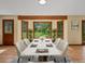 Bright dining room with a large window, a wood beam, and a stylish marble-topped table at 11824 E Basswood Ln, Franktown, CO 80116