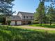 Charming two-story home with a three-car garage and a beautiful, sprawling lawn at 11824 E Basswood Ln, Franktown, CO 80116