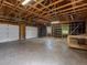 Large, unfinished garage with multiple bays, windows, and overhead lighting at 11824 E Basswood Ln, Franktown, CO 80116