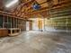 Spacious garage with overhead storage and access door to the yard at 11824 E Basswood Ln, Franktown, CO 80116