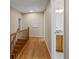 Hallway showcasing hardwood floors, neutral walls, and access to a bathroom, adding a modern touch to the home at 11824 E Basswood Ln, Franktown, CO 80116