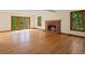 Bright and spacious living room featuring a brick fireplace and access to a serene outdoor space at 11824 E Basswood Ln, Franktown, CO 80116