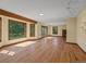 Large, airy living room featuring hardwood floors, a fireplace, and access to an outdoor patio at 11824 E Basswood Ln, Franktown, CO 80116