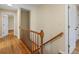 The staircase features wood handrails, hardwood floors, and white walls, enhancing the home's classic charm at 11824 E Basswood Ln, Franktown, CO 80116