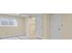 Basement room with light gray wood floors, white trim, a window, and white doors to storage and bathroom at 19828 E Brown Pl, Aurora, CO 80013