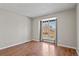 Bedroom featuring hardwood floors and a window with decorative gray curtains at 19828 E Brown Pl, Aurora, CO 80013