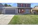 Beautiful two-story home with a well-manicured lawn, an attached garage, and colorful accents at 19828 E Brown Pl, Aurora, CO 80013