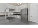 Well-lit kitchen featuring stainless steel appliances, white cabinets, and gray countertops at 19828 E Brown Pl, Aurora, CO 80013