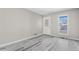 Bright, open living room with sleek floors, a large window, and neutral wall colors at 19828 E Brown Pl, Aurora, CO 80013