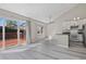 Open-concept living space with gray floors, a sliding glass door to the deck and eat-in kitchen at 19828 E Brown Pl, Aurora, CO 80013