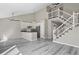 Open-concept living area featuring modern kitchen, high ceilings, and a staircase at 19828 E Brown Pl, Aurora, CO 80013