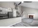 Open-concept living area featuring kitchen, living room, modern floors and a fireplace at 19828 E Brown Pl, Aurora, CO 80013
