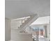 Bright stairway leading to upper floor with gray floors and views of the backyard at 19828 E Brown Pl, Aurora, CO 80013