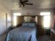 Bright bedroom with a queen bed, ceiling fan, and built-in storage providing lots of space at 1998 E 100Th Pl, Thornton, CO 80229