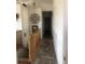 This tiled hallway has stairs and tasteful decorations, connecting the home's upper and lower levels at 1998 E 100Th Pl, Thornton, CO 80229