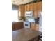Efficient kitchen features warm wood cabinets, white appliances, and a center island with seating at 1998 E 100Th Pl, Thornton, CO 80229