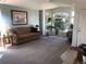 Bright living room features large bay windows, neutral carpet, and a cozy seating area at 1998 E 100Th Pl, Thornton, CO 80229
