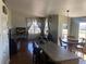 Open-concept living space featuring a kitchen island, dining area, and comfortable seating near a window at 1998 E 100Th Pl, Thornton, CO 80229