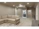 Spacious carpeted basement with large sectional sofa and access to other rooms at 23130 E Del Norte Cir, Aurora, CO 80016