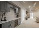 Finished basement with bar area featuring custom cabinets, wine cooler, and beverage fridge at 23130 E Del Norte Cir, Aurora, CO 80016