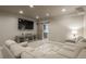 Relaxing basement living area with large screen tv, comfortable sofa, and sliding barn door at 23130 E Del Norte Cir, Aurora, CO 80016