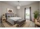 Stylish bedroom features a large window, designer rug, and elegant lighting at 23130 E Del Norte Cir, Aurora, CO 80016