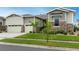 Charming two-story home featuring a manicured lawn, stone accents, and an attached two-car garage at 23130 E Del Norte Cir, Aurora, CO 80016