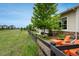 Home exterior features a neat yard with beautiful views, orange chairs, and a black fence at 23130 E Del Norte Cir, Aurora, CO 80016