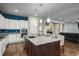 Spacious kitchen boasts an expansive island with seating and sleek granite countertops at 23130 E Del Norte Cir, Aurora, CO 80016