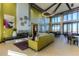 A brightly lit community living space with high ceilings, modern decor, and floor to ceiling windows at 23130 E Del Norte Cir, Aurora, CO 80016