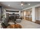 Open living space with hardwood floors, a stylish sofa, and seamless flow to the adjacent kitchen and foyer at 23130 E Del Norte Cir, Aurora, CO 80016