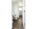 Bathroom with a toilet, sink, laundry machine, and wood-look floors at 2732 E 132Nd Pl, Thornton, CO 80241