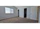 Neutral carpeted bedroom features natural light from a large window and is adjacent to bathroom and closet at 2732 E 132Nd Pl, Thornton, CO 80241