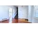 Inviting entryway with hardwood floors, a white door, and a view of the staircase at 2732 E 132Nd Pl, Thornton, CO 80241