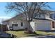 Charming two-story home with a well-maintained lawn and landscaping around the front tree at 2732 E 132Nd Pl, Thornton, CO 80241