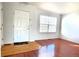 Bright living room featuring hardwood floors and a large window for ample natural light at 2732 E 132Nd Pl, Thornton, CO 80241