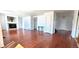 Open-concept living room featuring a fireplace, hardwood floors and neutral wall paint at 2732 E 132Nd Pl, Thornton, CO 80241