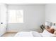 Bright bedroom features a clean design with a window, white walls, and hardwood floors at 4025 E Martin Luther King Jr, Denver, CO 80207