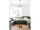 Bright kitchen nook featuring built-in banquette seating with hardwood floors at 4025 E Martin Luther King Jr, Denver, CO 80207