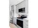 Modern kitchen featuring stainless steel appliances and sleek gray cabinetry for a contemporary look at 4025 E Martin Luther King Jr, Denver, CO 80207