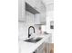 Bright kitchen featuring sleek countertops, stainless steel sink, and modern gray cabinetry at 4025 E Martin Luther King Jr, Denver, CO 80207