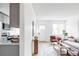 Modern living room with hardwood floors, view to the kitchen, and ample sunlight from a nearby window at 4025 E Martin Luther King Jr, Denver, CO 80207