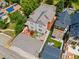 Aerial view of home showcasing patio, outdoor seating, manicured lawn, mature trees, and surrounding neighborhood at 1551 S Grant St, Denver, CO 80210
