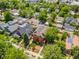 Aerial view showcasing the home's landscaping, large yard, mature trees, and surrounding neighborhood at 1551 S Grant St, Denver, CO 80210