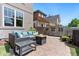 Inviting backyard patio with a cozy fire pit, outdoor seating, and manicured landscaping at 1551 S Grant St, Denver, CO 80210