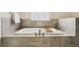 Luxurious bathroom featuring an oversized soaking tub with tile surround and elegant fixtures at 1551 S Grant St, Denver, CO 80210